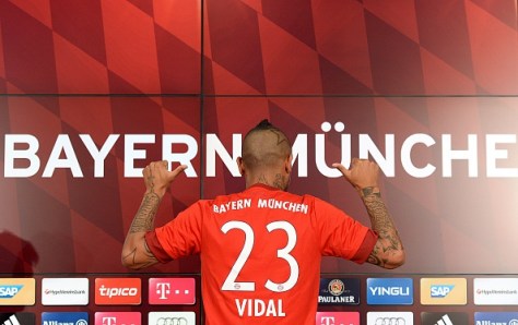 German first division Bundesliga football club Bayern Munich's new recruit Chilean midfielder Arturo Vidal shows his jersey during a press conference on July 28, 2015, in Munich, southern Germany. Vidal is set for his second stint in the Bundesliga having spent four seasons at Bayer Leverkusen from 2007-2011.  AFP PHOTO / CHRISTOF STACHE        (Photo credit should read CHRISTOF STACHE/AFP/Getty Images)